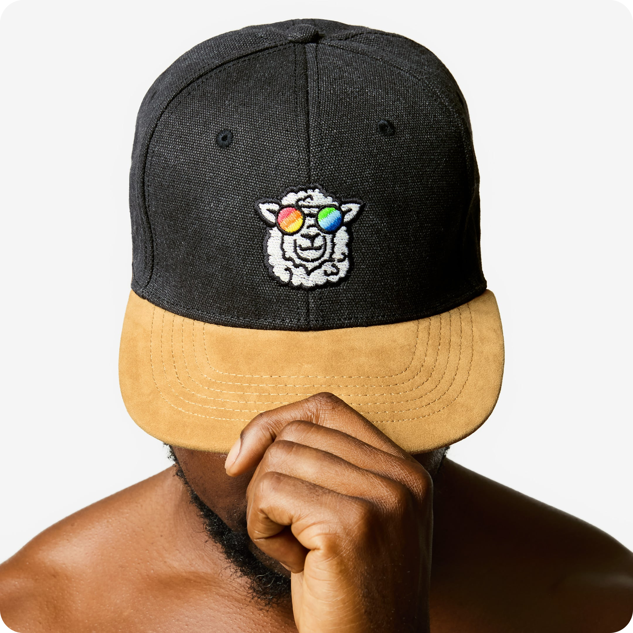 "Sunny" Skater Cap with a sheep motif made of gay sheep wool on a male model’s head.