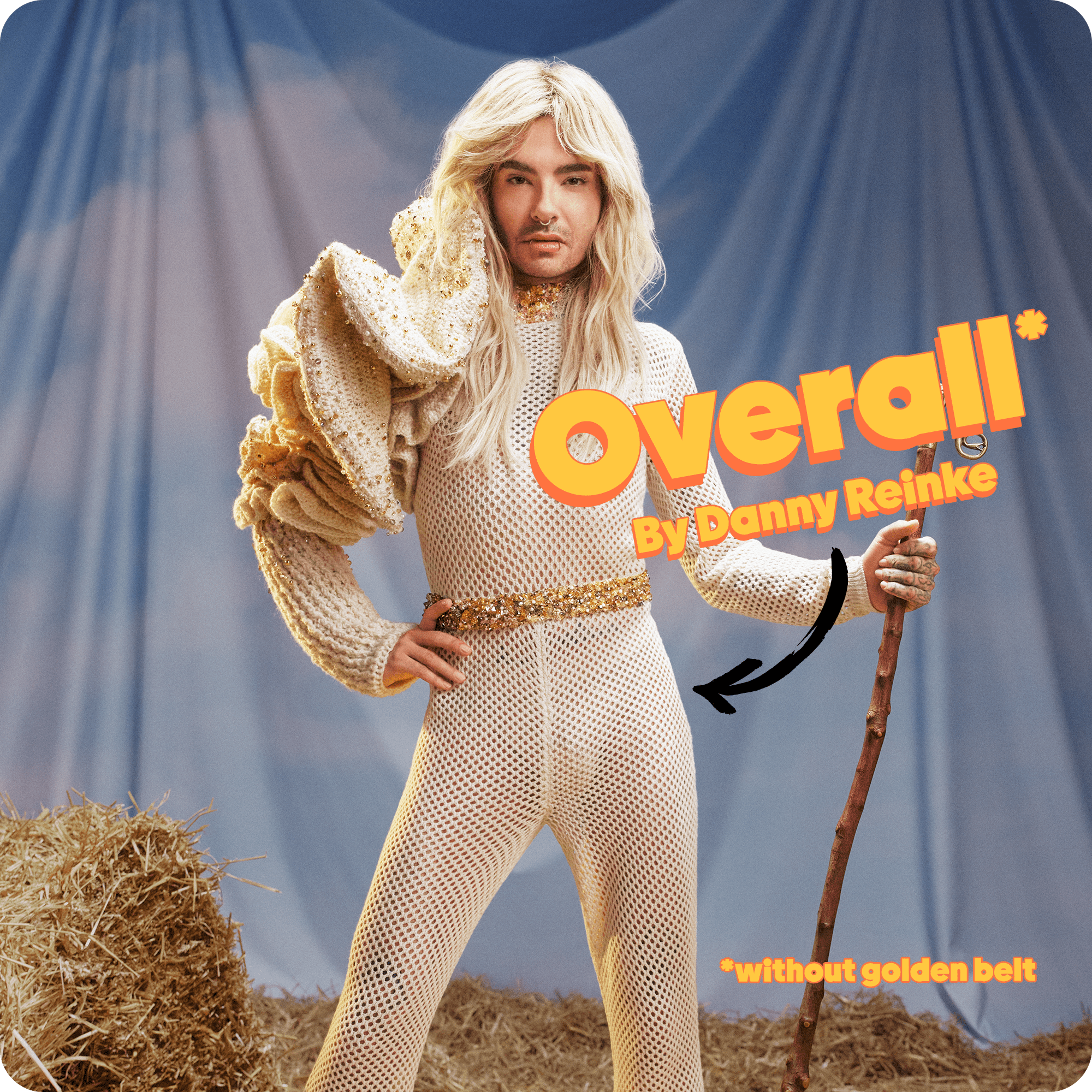 Bill Kaulitz looking straight into the camera posing and wearing the overall.